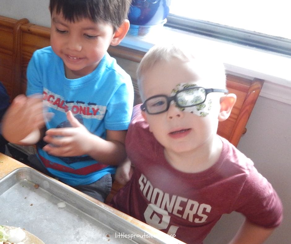 Kids cooking together at the table learning skills to build self-esteem