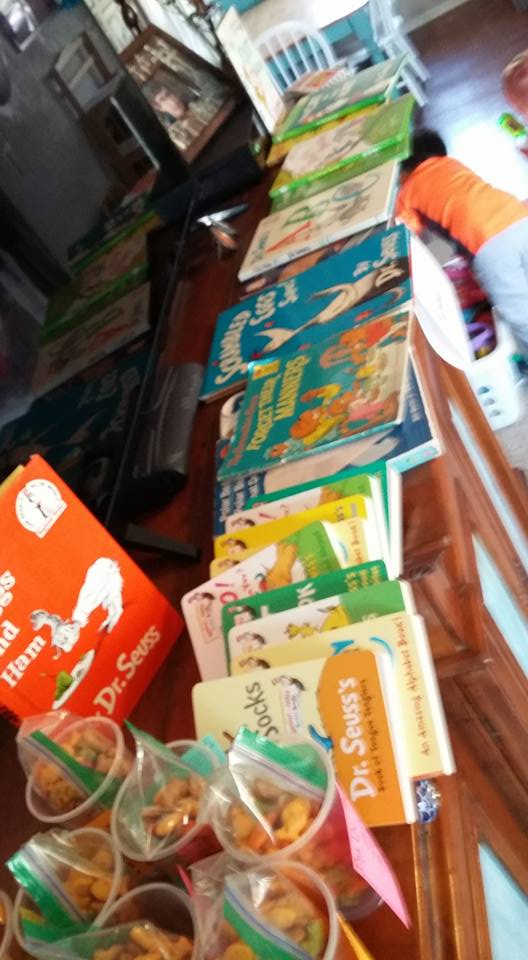 Dr. Seuss books and treats lined up on a cabinet from dr. Seuss party
