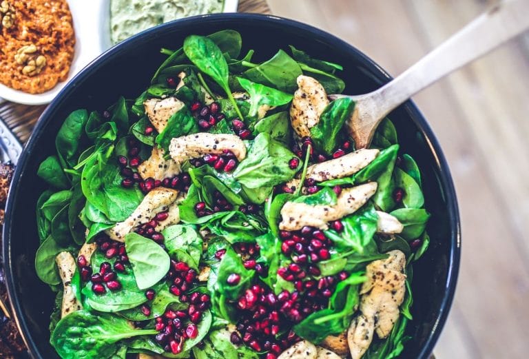 pretty green salad with grilled chicken and pomegranate seeds