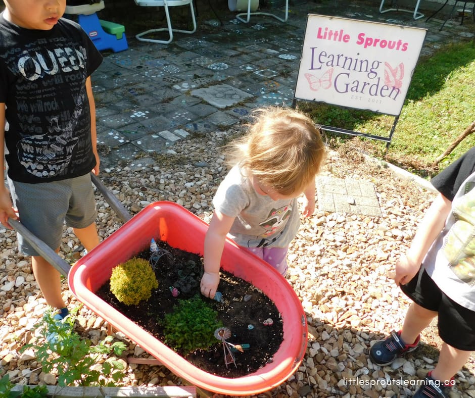 Kids playing with a fairy garden