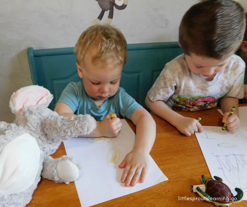 kids coloring animal color sheets at zoo party.
