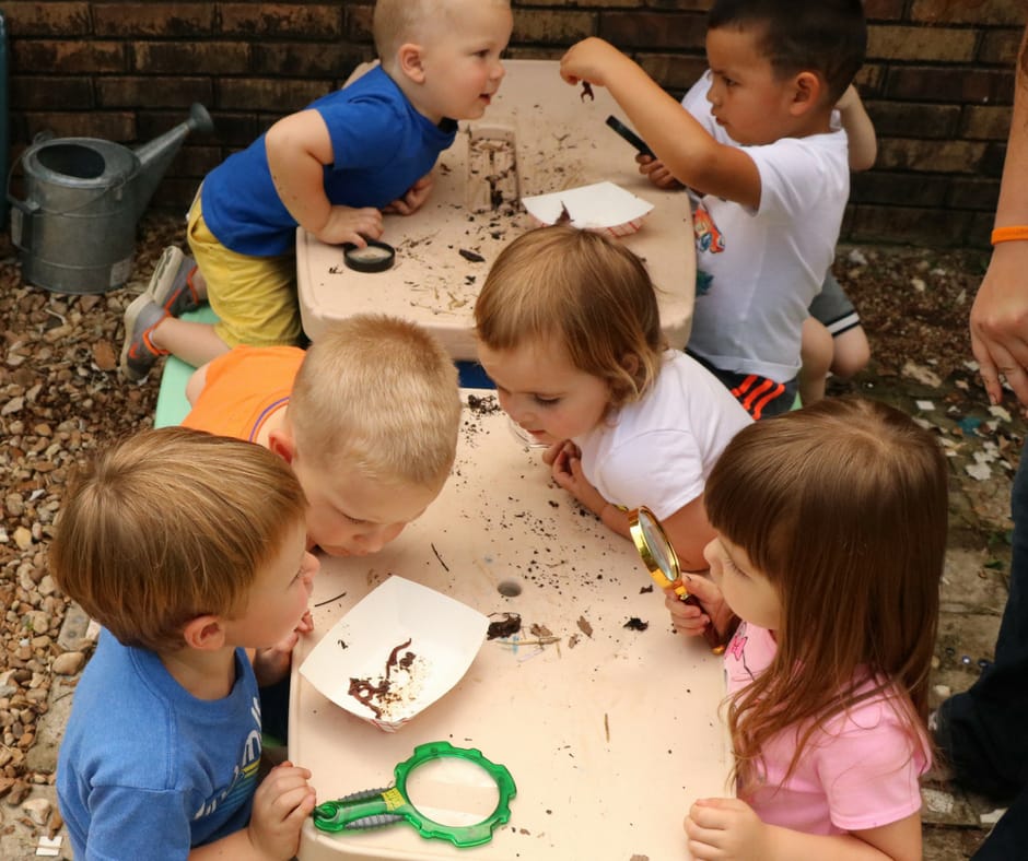 kids observing worms for composting