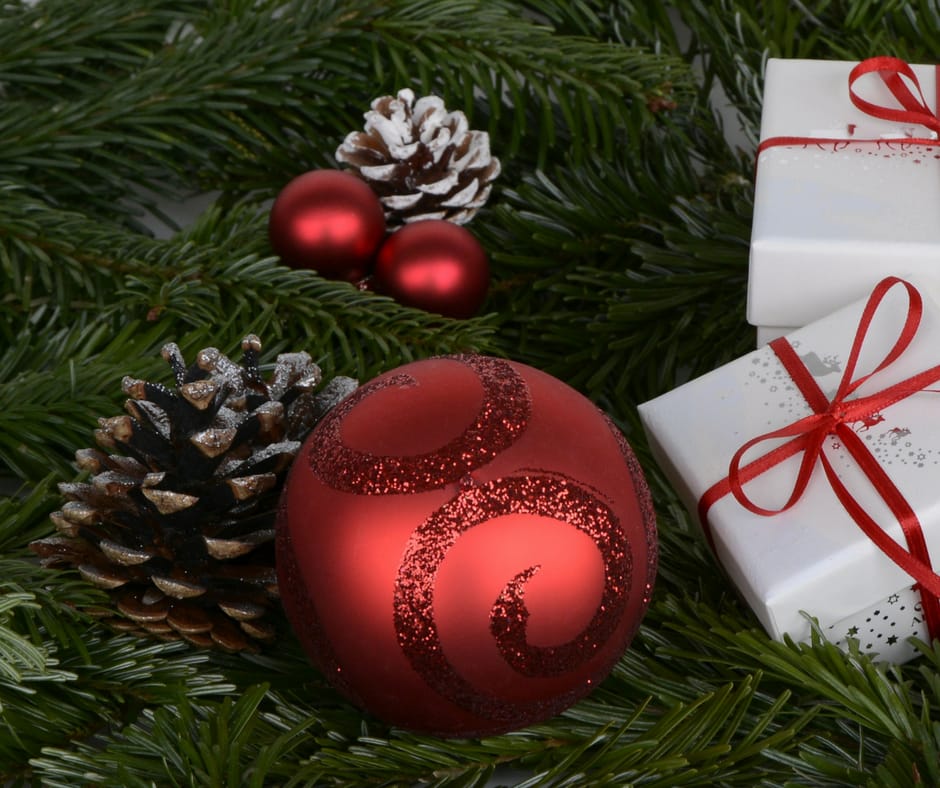 Greenery with small wrapped gifts, pinecones and christmas ornament balls
