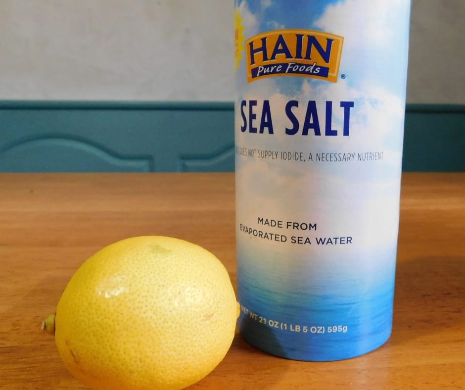 salt and a lemon sitting on table