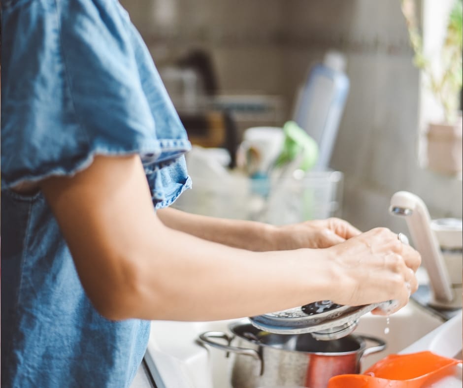 woman standing at sink cleaning naturally