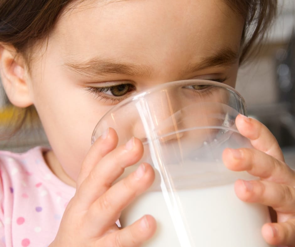 eco-healthy home based child care, child drinking milk from a class