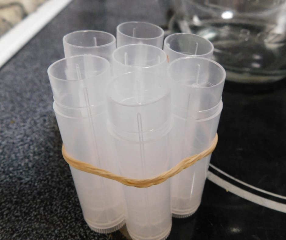 empty lip balm tubes tied together with rubber bands