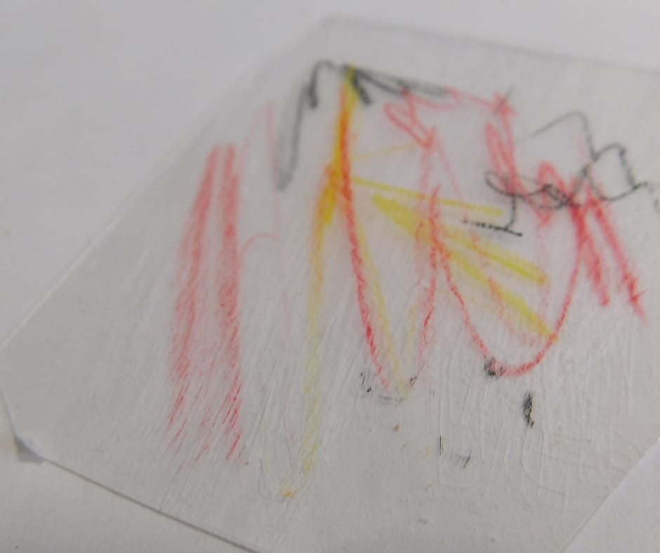 Child's art on shrinky dink plastic.