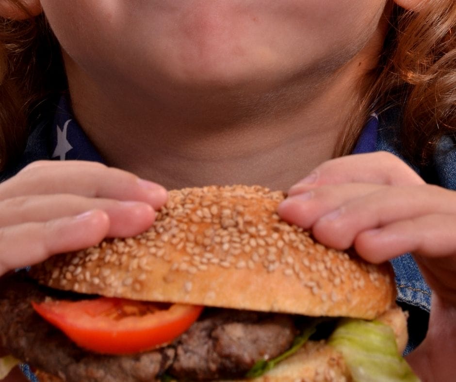 toddler holding sandwich