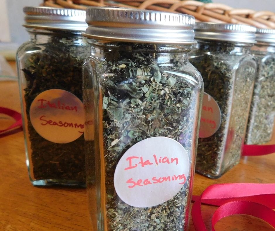 Italian seasoning blend in jars on the table with red ribbons