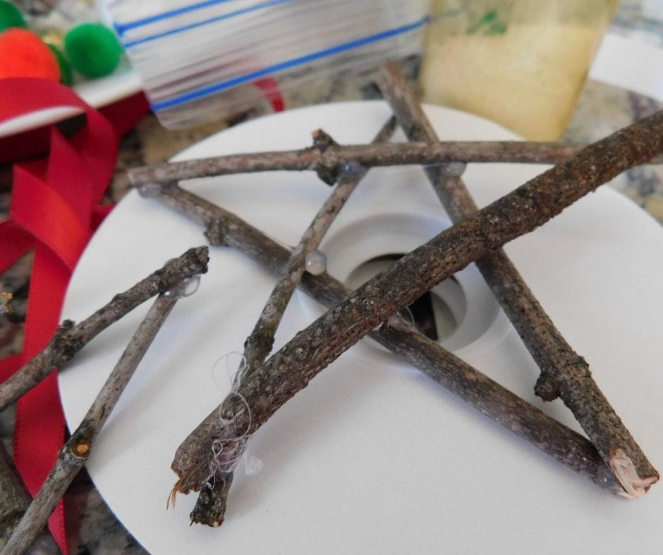 small twigs cut into 4-5 inch pieces and hot glued together to make a star shaped ornament