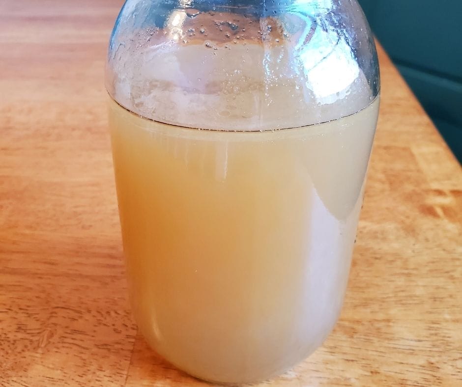 Grass fed bone broth in a mason jar on the table