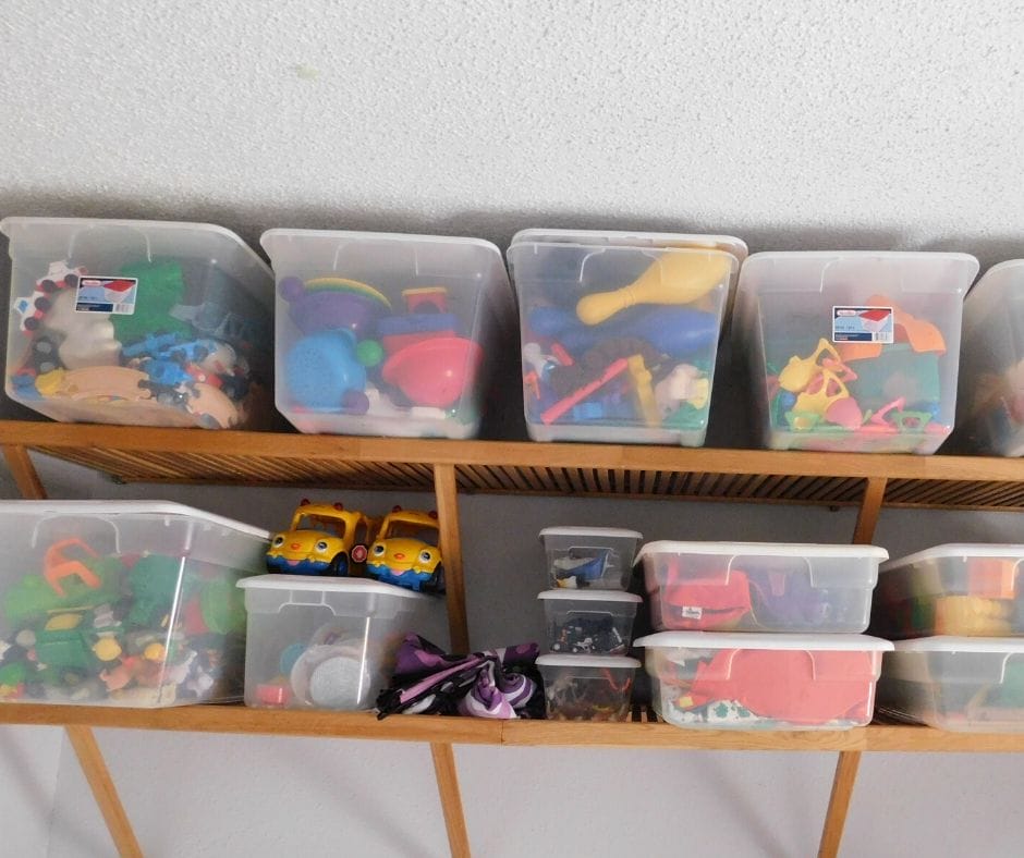 Toys in clear bins on shelves.