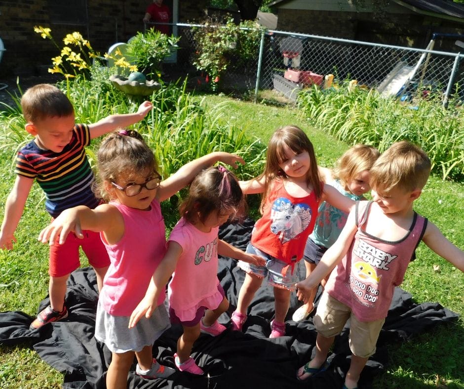 kids doing garden yoga