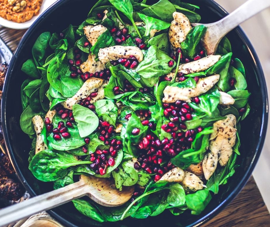 Salad with chicken, spinach, and pomegranites