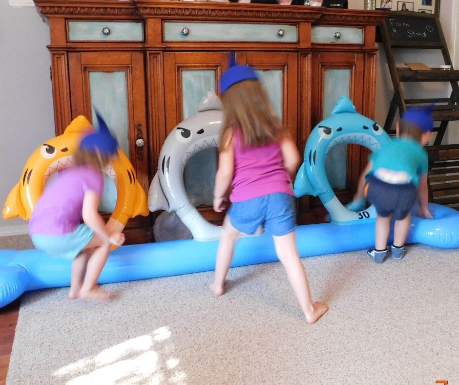 kids playing shark ring toss at shark party
