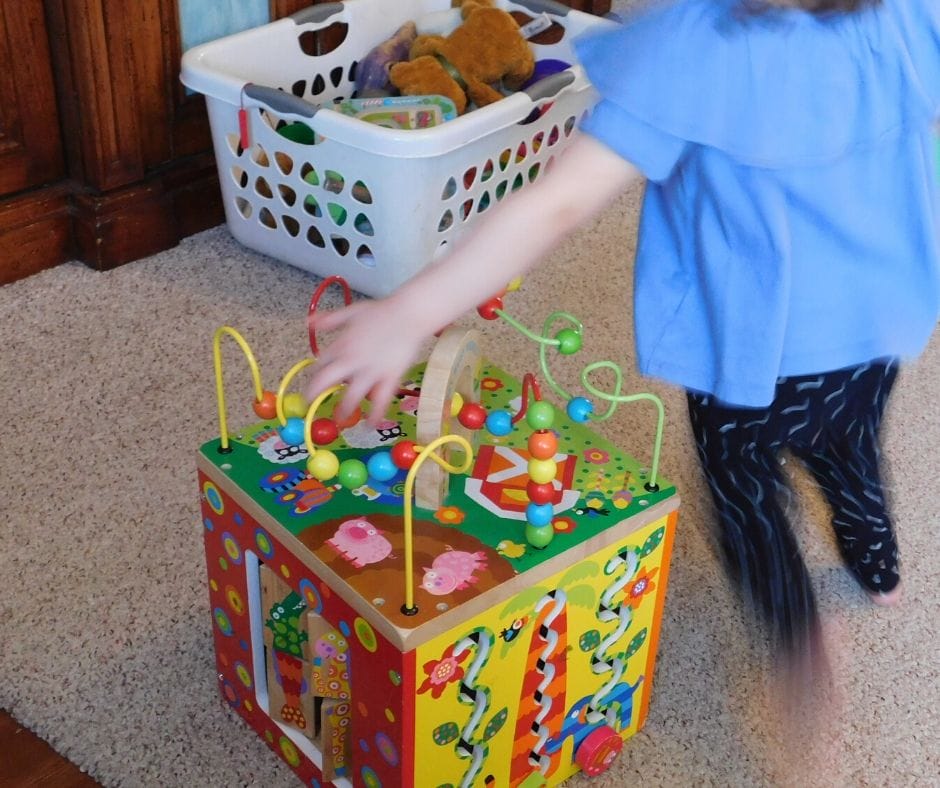 child going around the busy beads at the indoor obstacle course