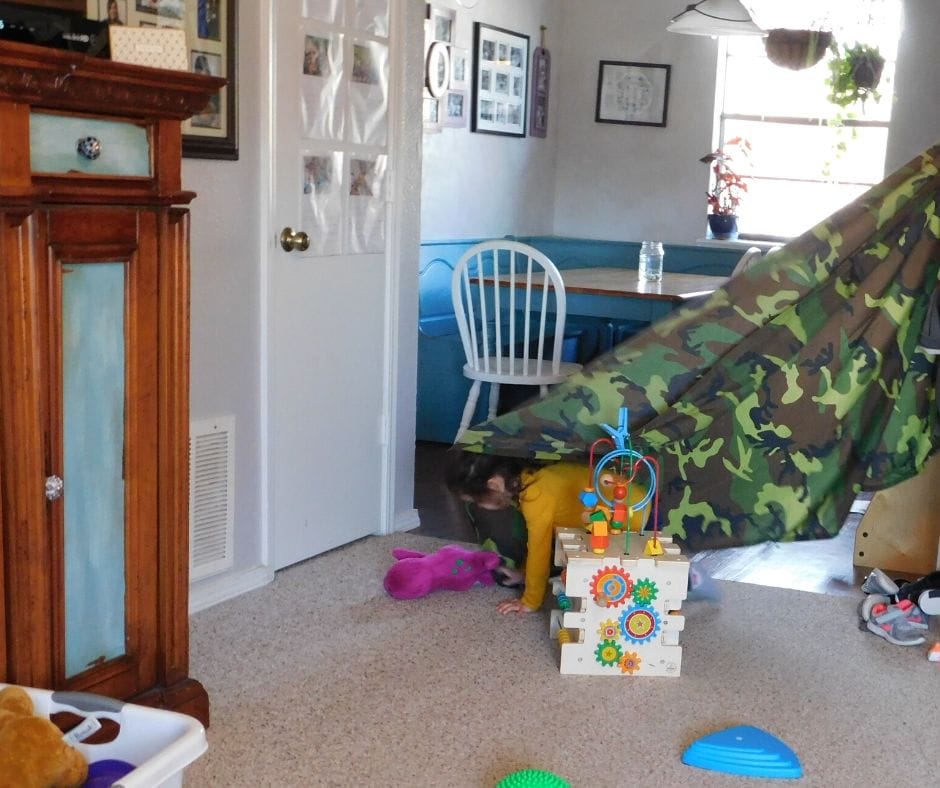 child going under the tarp indoor obstacle course