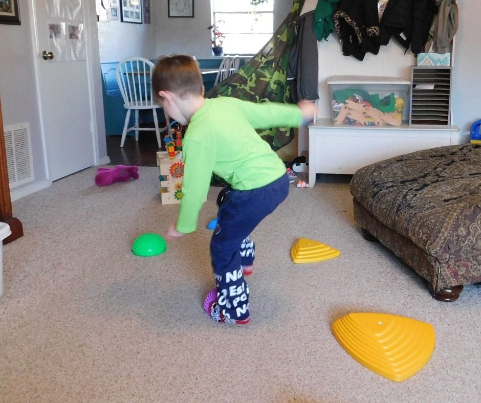 child jumping on balancing balls