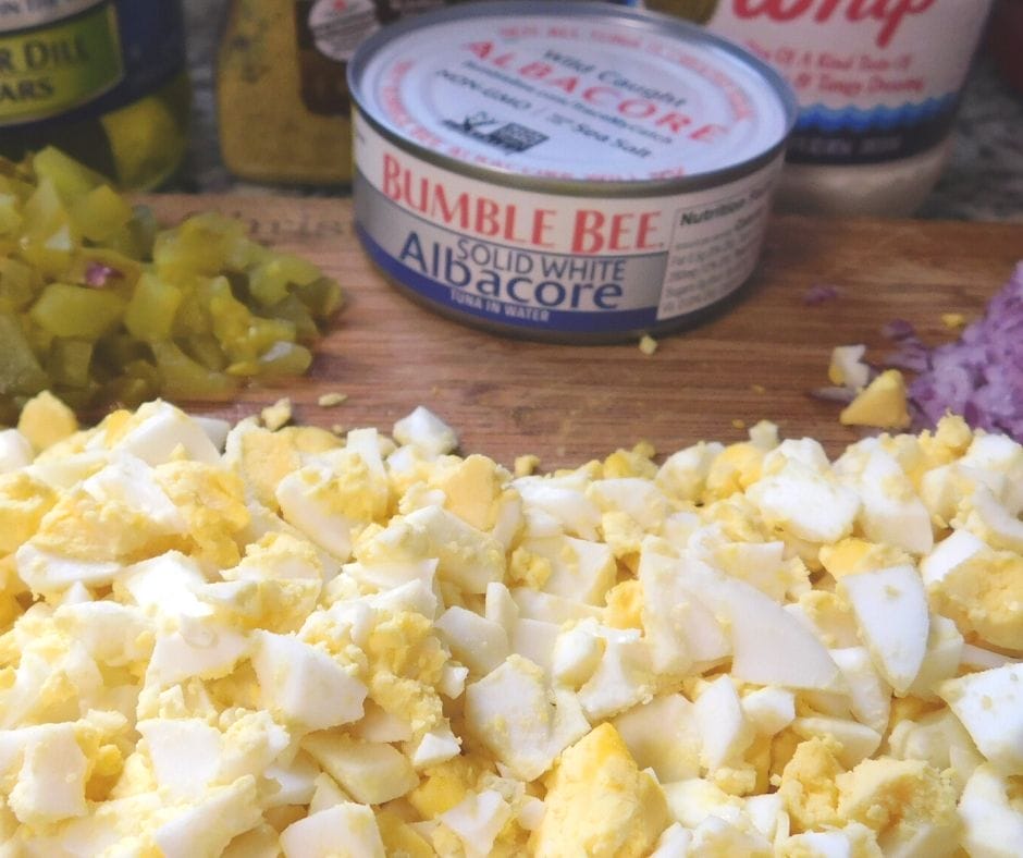 tuna salad recipe with egg ingredients on cutting board