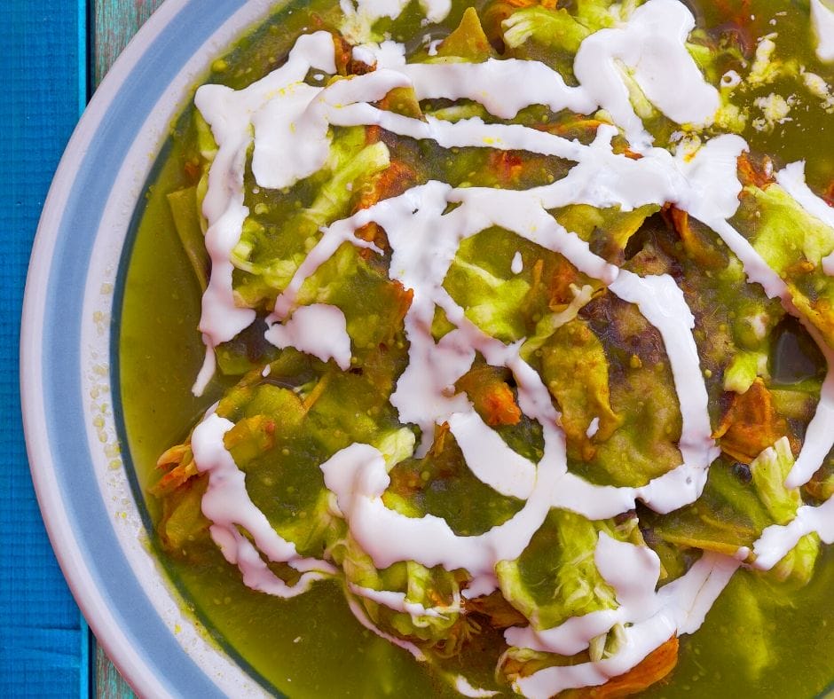 pork verde in a bowl toped with sour cream