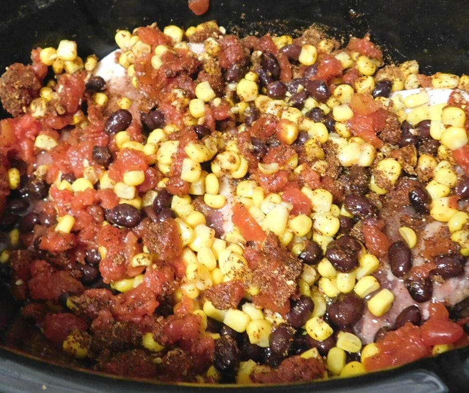 corn, rotel, and black beans on pork chops in the crock pot