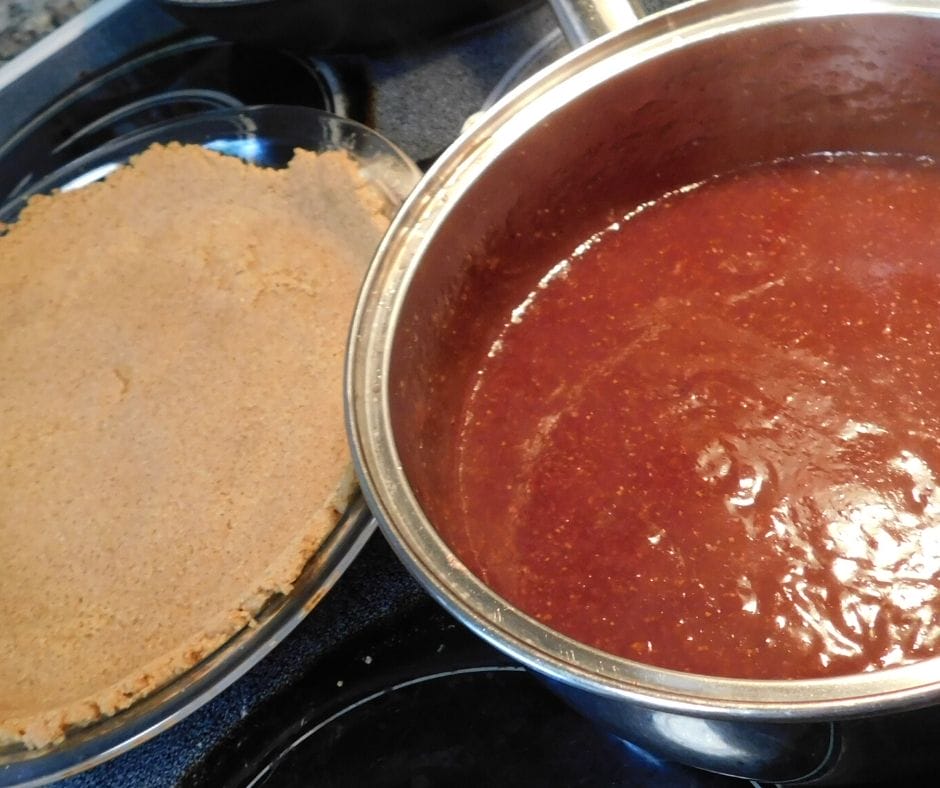 graham cracker crust and pie filling on the stove top