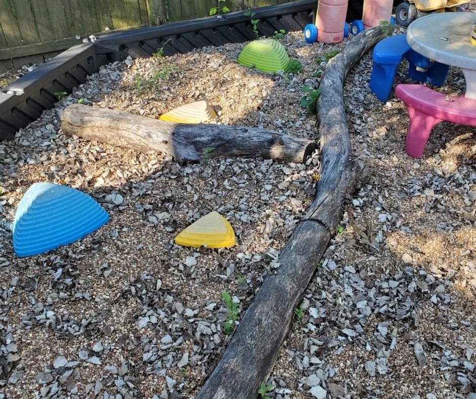 natural playscape, large tree branches for balance beam