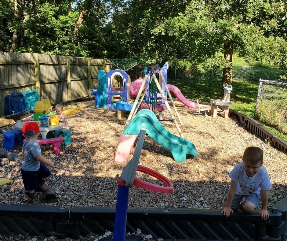 home daycare playground with swing set, climbers, slides, and other toys