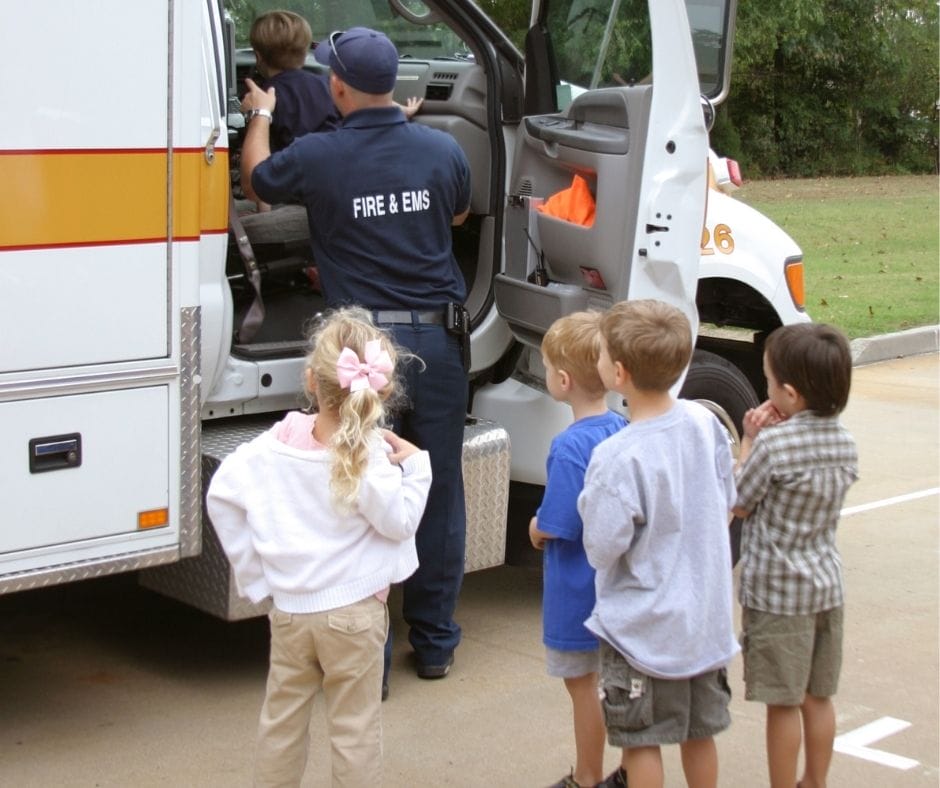 Kids looking in an ambulance learning about it