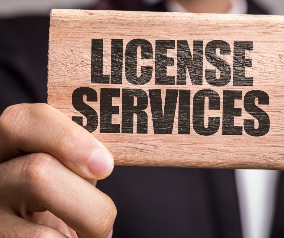 wooden sign that says license services