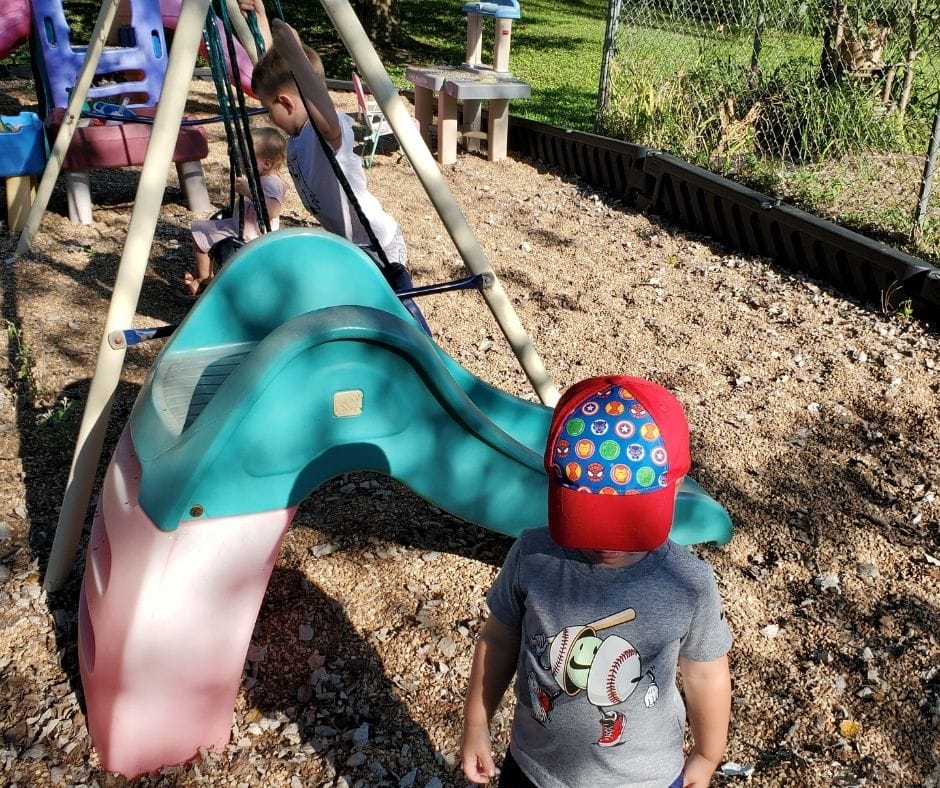 Kids playing outside at home daycare.