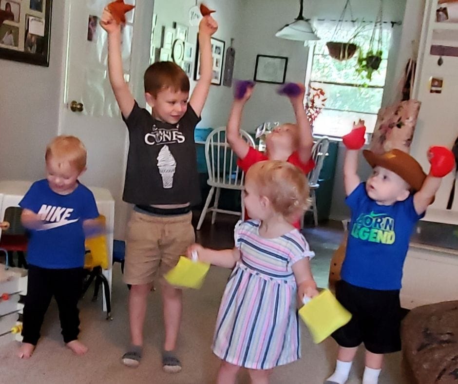 kids playing with shape bean bags in home daycare
