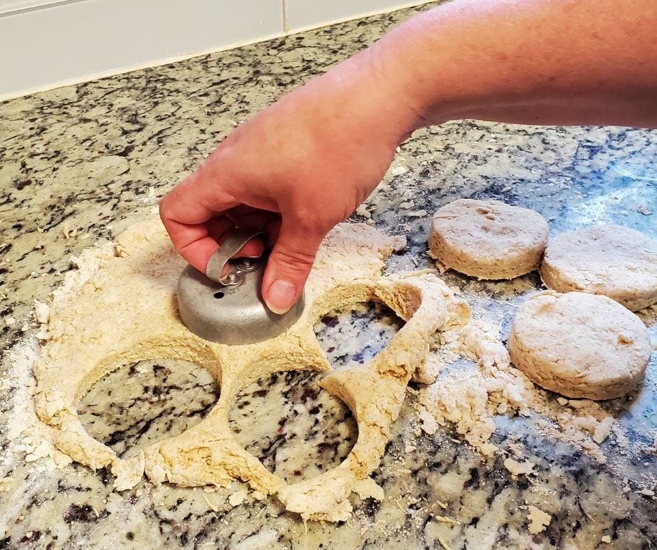 cutting biscuits out of dough