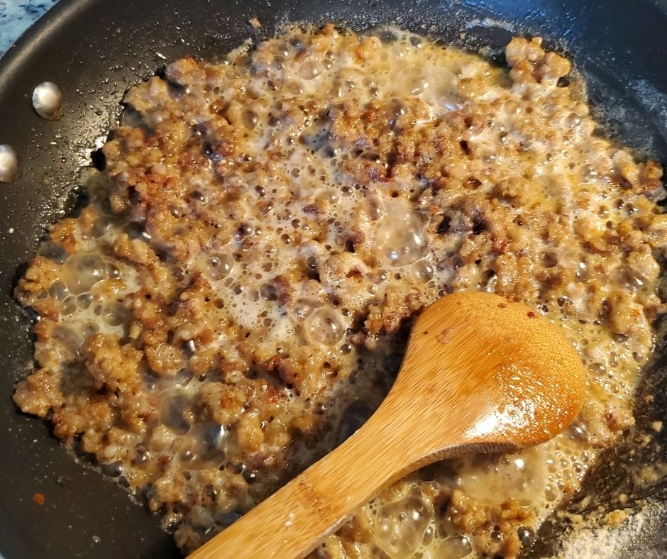cooking rue on the stove in a skillet for sausage gravy