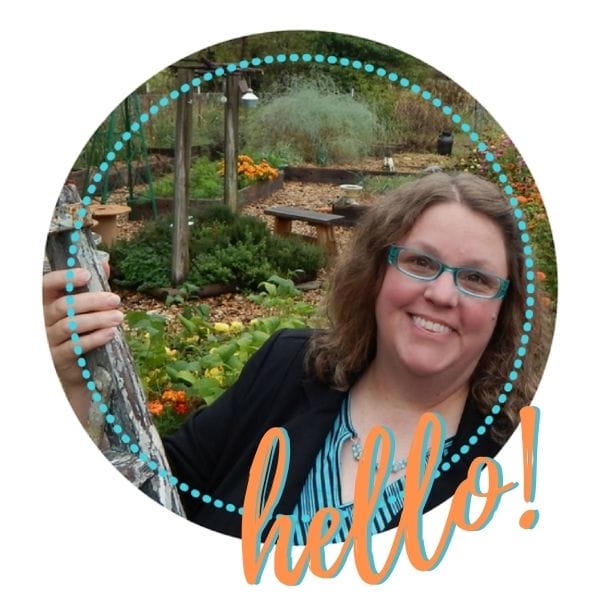 Little Sprouts home daycare provider Christina in her preschool garden showing the food the kids grow together.