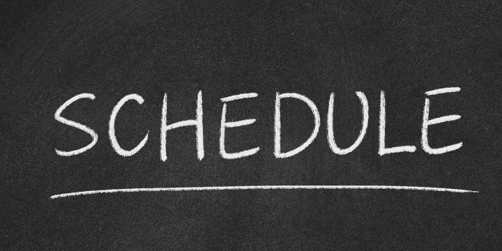 The phrase "DAILY SCHEDULE" is elegantly inscribed in white chalk on a blackboard backdrop, accentuated by an underscoring line.