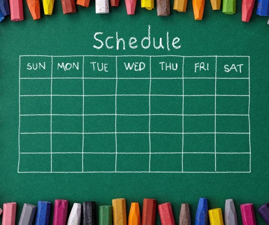 chalk board schedule with crayons all aroud the outside