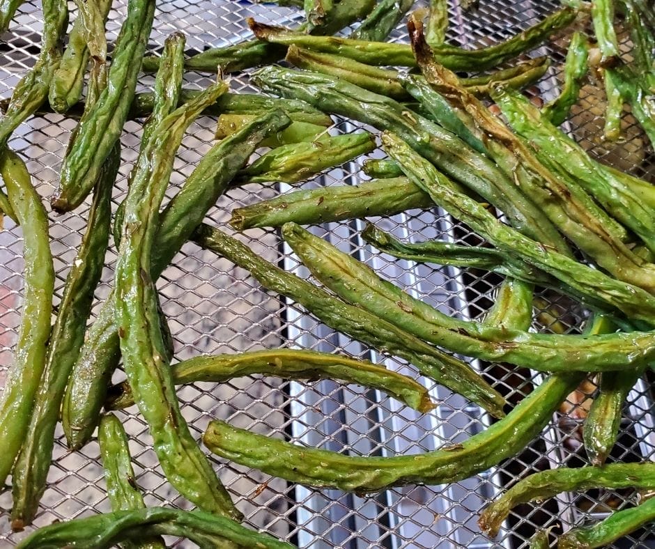 air fried green beans on the air fryer tray