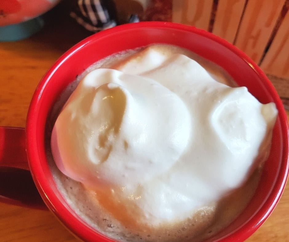 cup of homemade coffee drink with homemade vanilla syrup and whipped cream on top