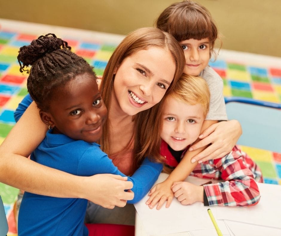 daycare provider with kids hugging