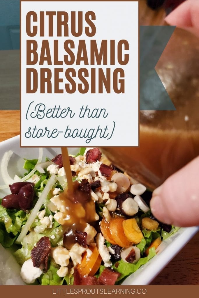 citrus balsamic dressing pouring out of a jar onto salad