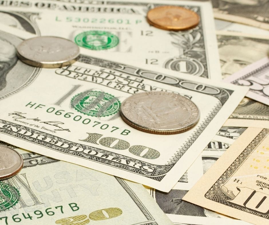 money laid out on a table with change on top