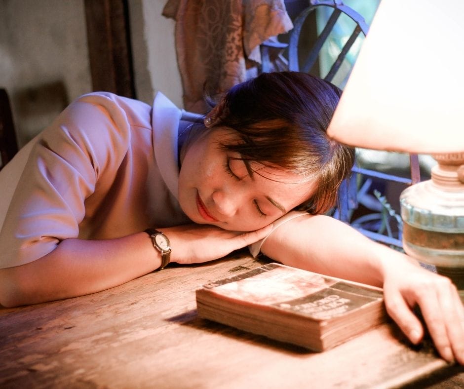 tired person who needs time off asleep on a desk