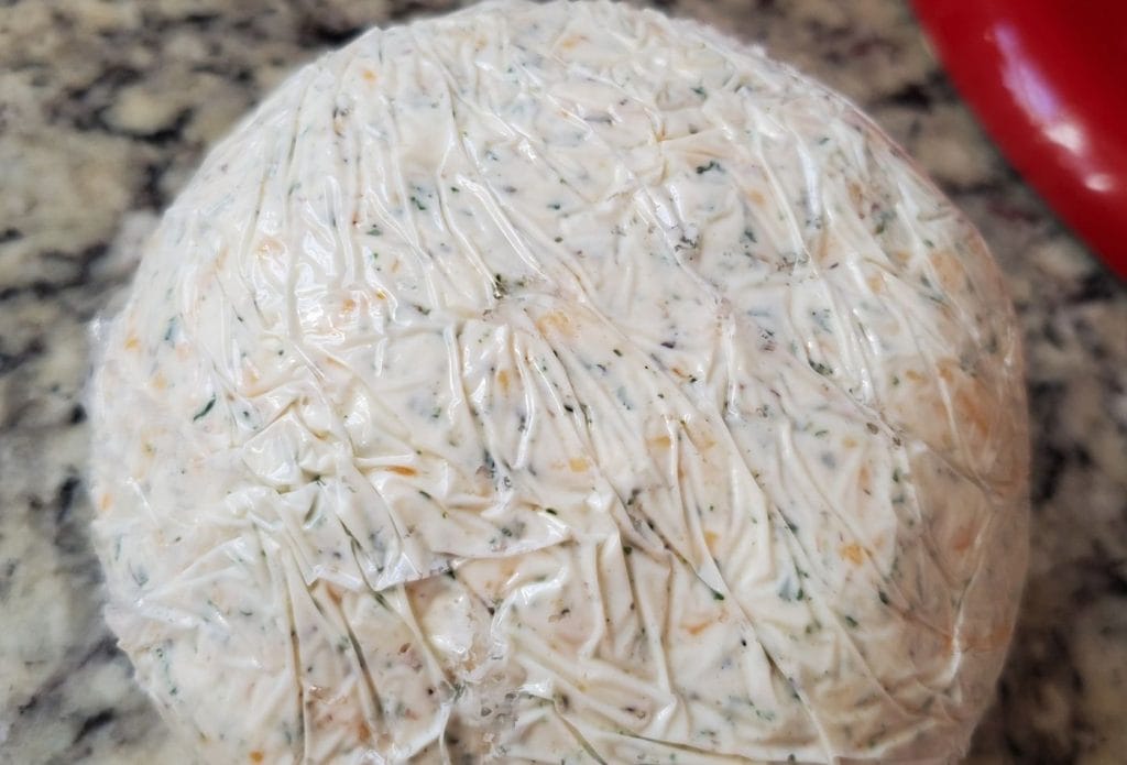 cream cheese and herbs in a ball for cheddar cheese ball