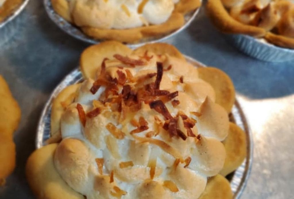 little 4 inch mini coconut tart on a tray full of them