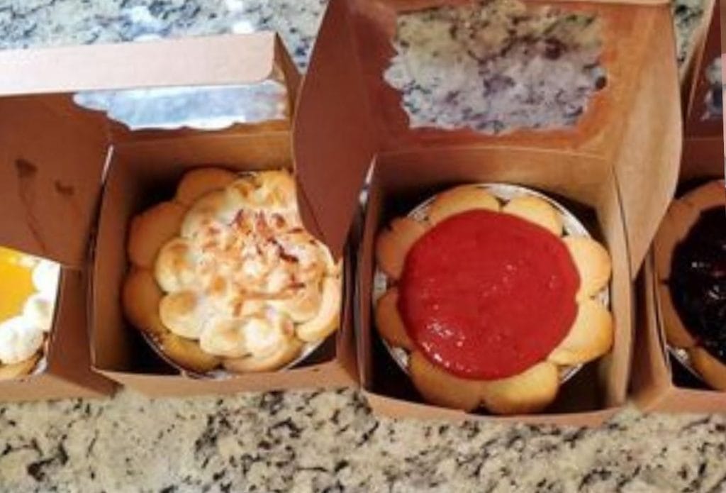 row of different mini tarts lined up on the table