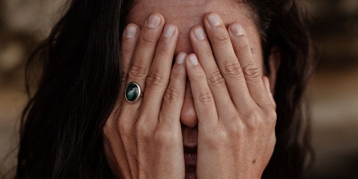 Woman covering her hands in frustration