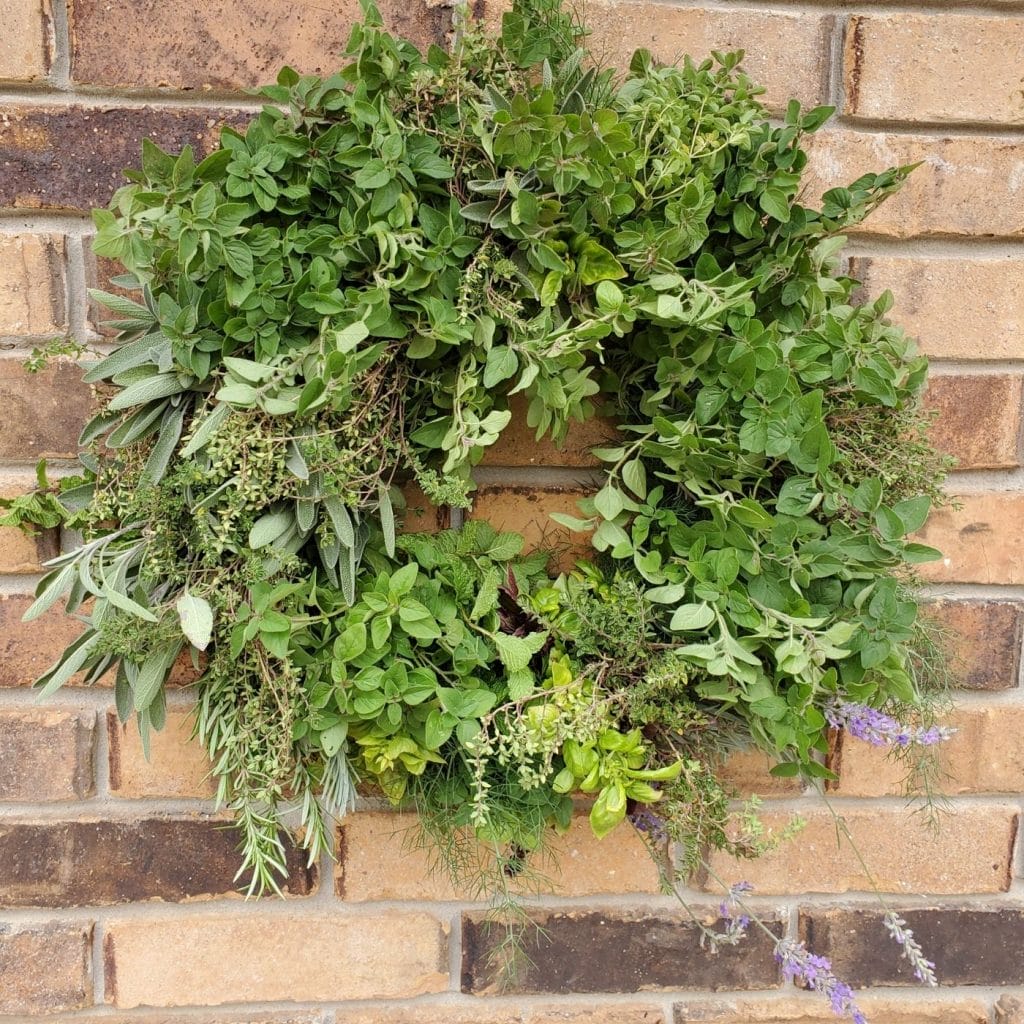 herb wreath hanging on a brick wall