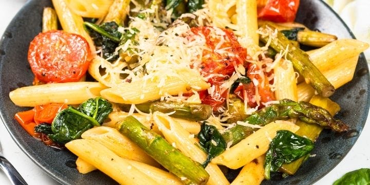 Meatless Pasta dinner with fresh vegetables and grated cheese